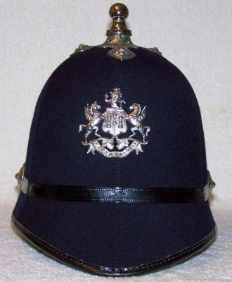 Exeter City Helmet, 1960's
Exeter City Helmet, 1960's, six panel design with chromed ball top and cross base, ear rosettes and coat of arms plate, black leather centre band
Keywords: exeter helmet Headwear